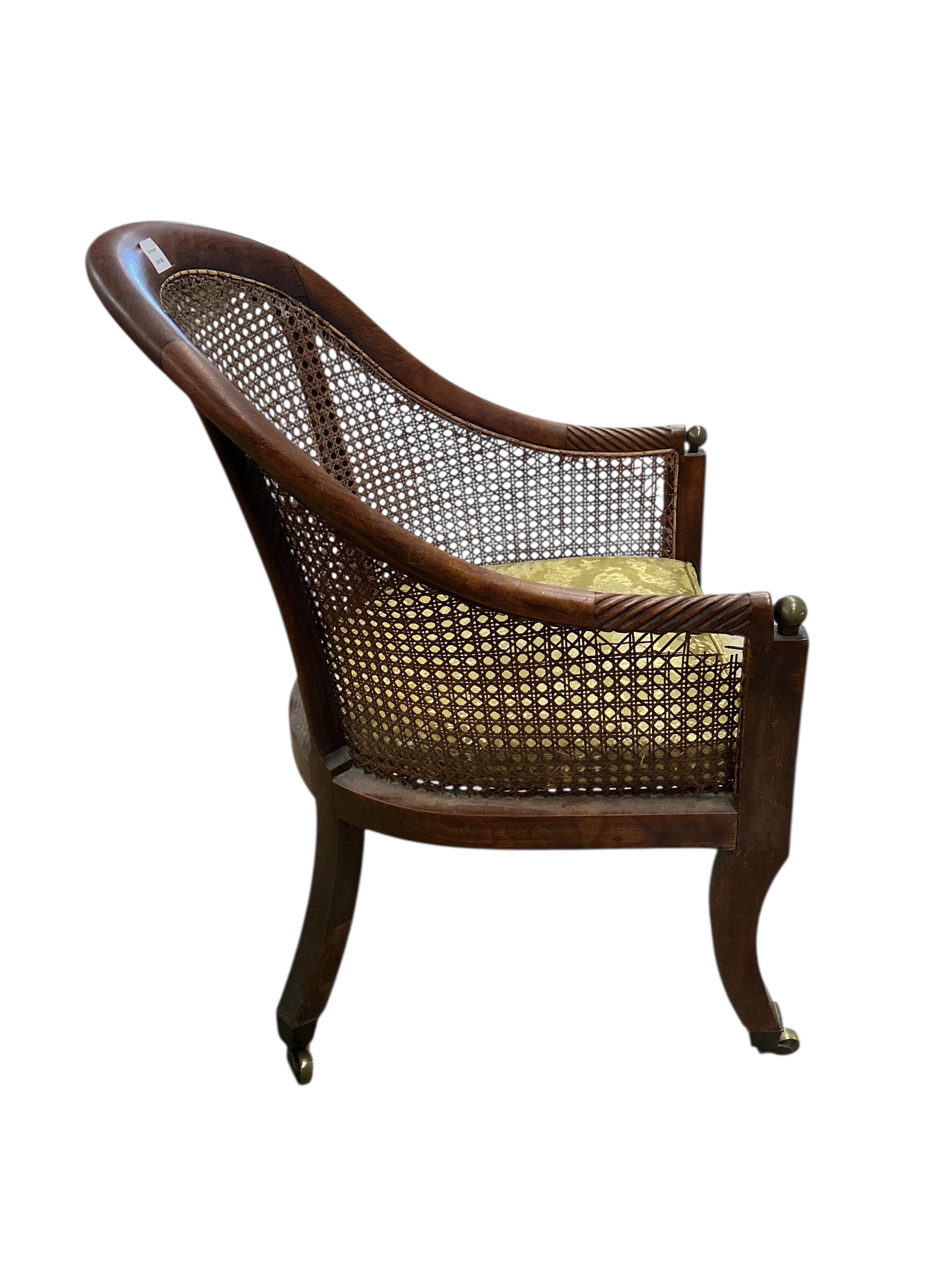 A Regency mahogany caned bergere armchair, (damaged cane) together with a Regency simulated rosewood and brass caned bergere armchair, larger width 49cm, depth 60cm, height 83cm